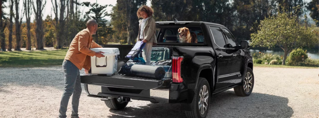 A family around a used Toyota Tacoma